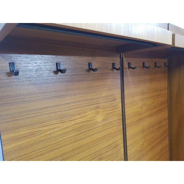 Original modular wardrobe covered with teak veneer. The furniture included in it creates an aesthetically coherent whole,...