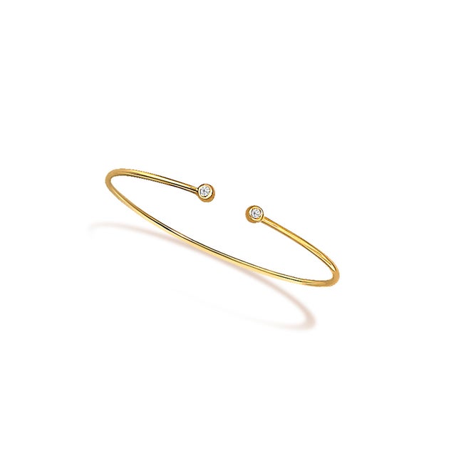 Immerse yourself in the delicate fusion of tradition and innovation with this exquisite bangle, elegantly crafted from...