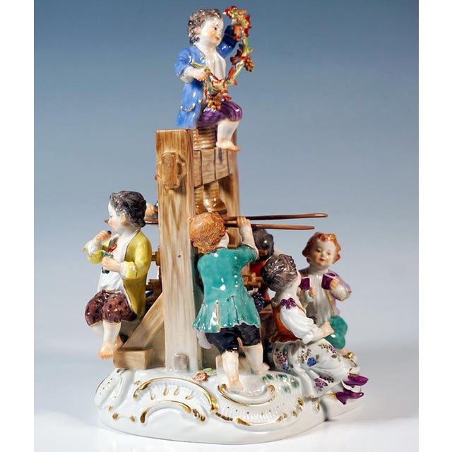 Excellent meissen porcelain sculpture: group of seven gardener children in elaborate rococo clothing placed around a wine...