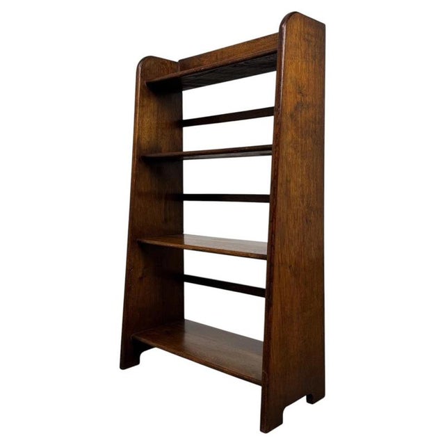 A handsome and finely crafted early 20th-century English open bookcase, constructed in richly grained oak and...