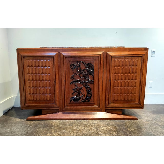 Sculptural, French Art-Deco, marble-top sideboard with lovely carved birds and flowers design on central door flanked by...