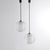Pair of Italian-made pendant lamps from the 1960s. Double-glass diffuser: the first is a clear sphere with embossed...