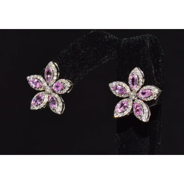 These exquisite earrings are crafted in an elegant five-petal floral design, each petal formed by a vivid marquise-cut...