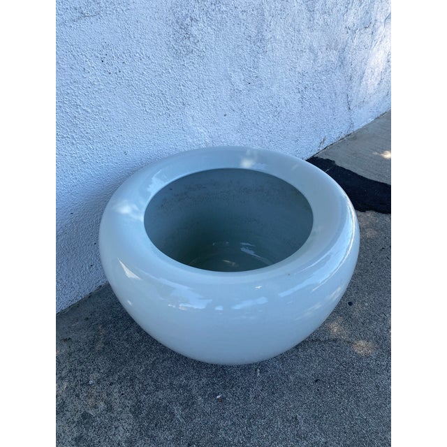 White porcelain fishbowl style Jardinere. Stylish addition for indoor plants. Incurving rim (lip) at the top helps keep...