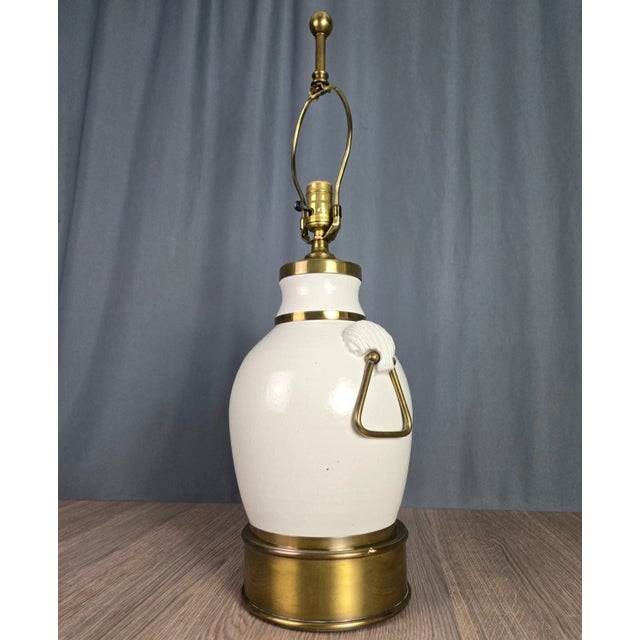 Impressive lamp by Hart, original sticker remains on the socket. Solid brass trim from the finial, the handles and base....
