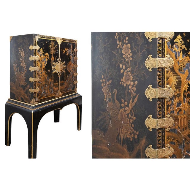 Cabinet on stand with nine drawers. Decorated with river landscapes, trees, birds and different animals. Lacquer losses in...