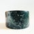 A vintage stone vessel. Nice modern cylinder shape. Beautiful moody dark green color with lovely natural variation to the...