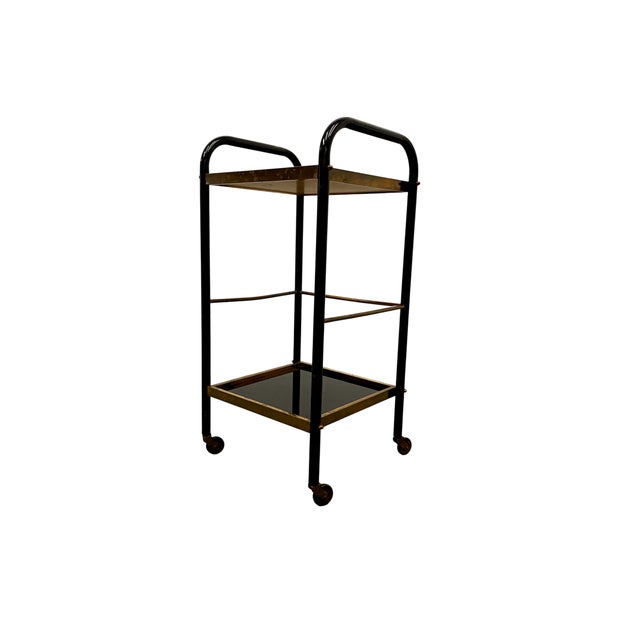 Handsome and classic mid century French serving trolley / bar cart. So sleek, with its black frame and elegant black glass...