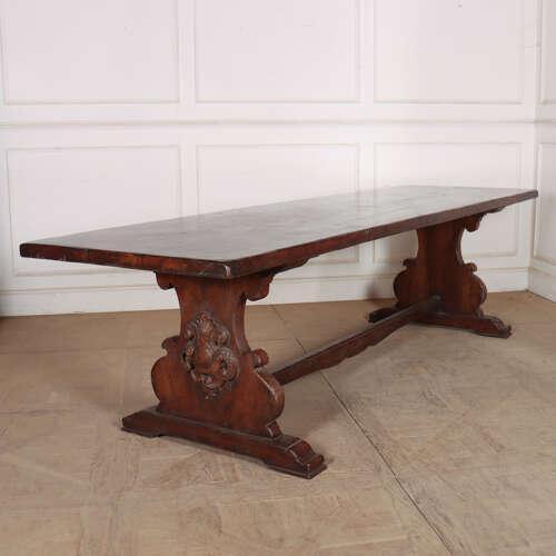 Wonderful early 20th century Italian walnut trestle table with a 2-inch thick top, carved trestle ends and a very good...