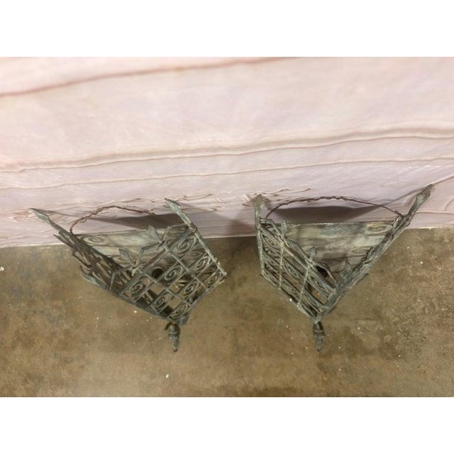 A spectacular pair of monumental Gothic Revival wrought iron wall sconces, guarded by mythical dragons — a true piece of...