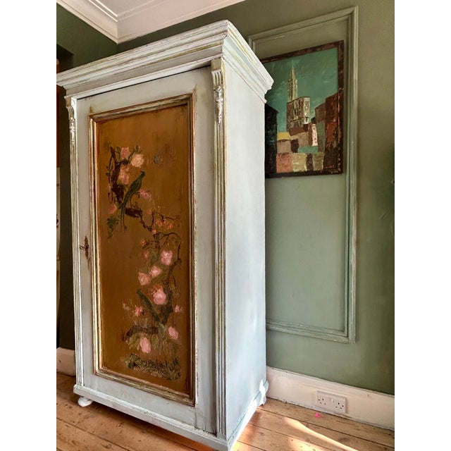 Vintage painted armoire, we have added a chinoiserie door panel depicting birds and flowers. Hanging rail and lock and...
