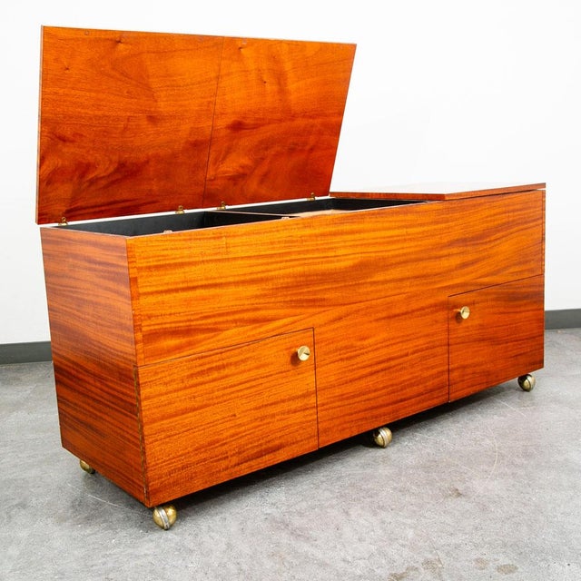 Beautiful mahogany audio cabinet with plenty of storage and functionality. Sits on brass casters. The top lids lift up if...