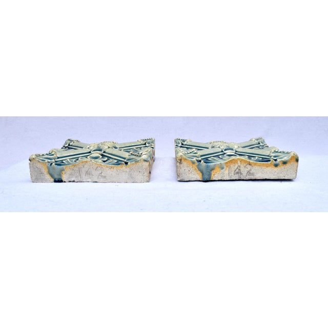 A pair antique hand made tiles purchased in France at the Paris Flea in the 70's,. Richly glazed floral X motif .