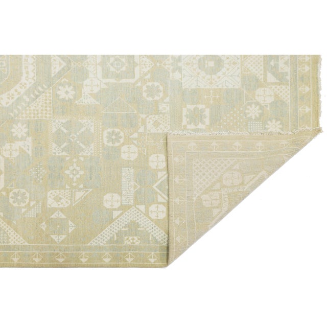 Elevate your space with the elegance of this Modern Khotan Style wool rug, inspired by Silk Road traditions. Featuring a...