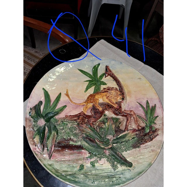 Large Ceramic Wall Platter with Relief Decoration – Lion Attacking an Ostrich This substantial glazed ceramic wall platter...