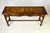 Vintage console table showcasing traditional craftsmanship and striking wood grain. The piece features an elegant...