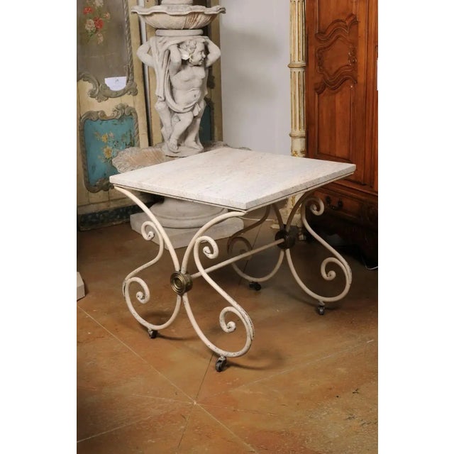 An antique French patisserie table from the late 19th century with recently added stone top and painted iron scrolling...