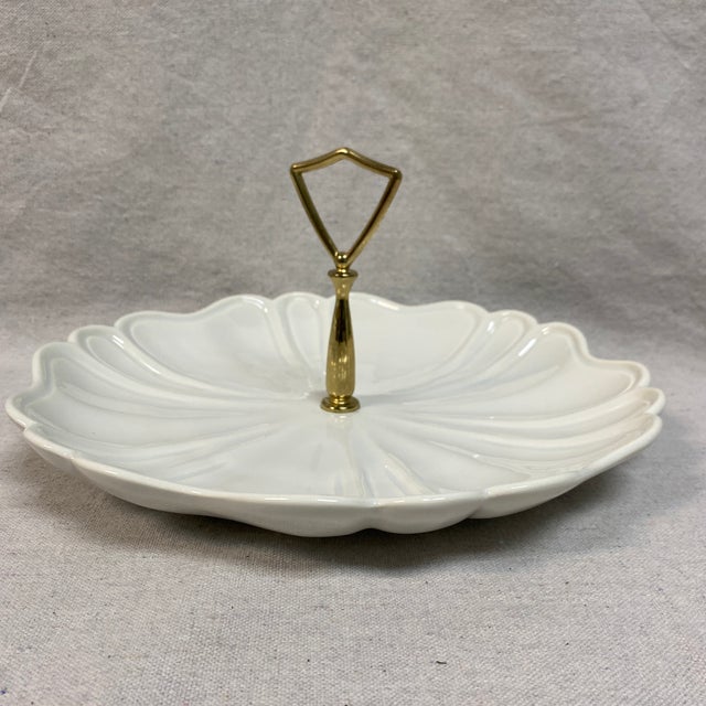 White glazed ceramic or pottery with a brass or gold-tone handle. Designed for serving snacks, candy, nuts, or hors...