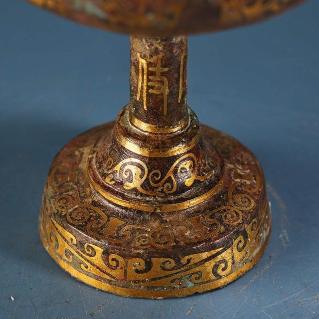 Fine archaic-style stemmed bronze incense burner with elaborate gold inlaid scroll and geometric patterns across the lid,...