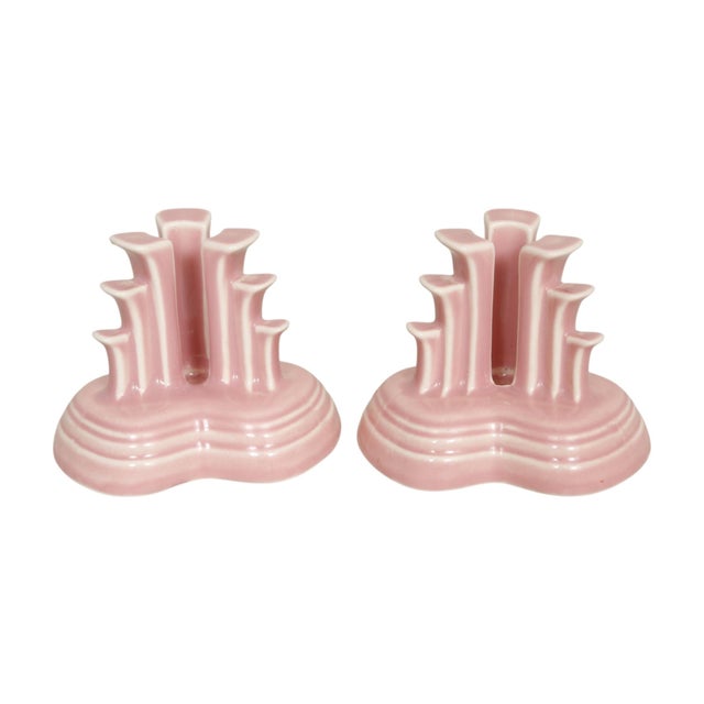A pair of American made “tripod” candlestick holders from the Fiesta Rose collection, by Homer Laughlin China Company....