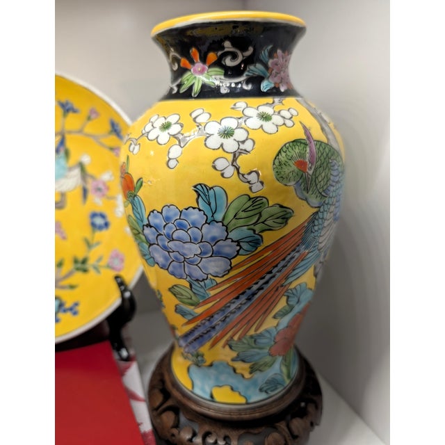 A beautiful vintage yellow ground porcelain vase and matching decorative plate featuring vibrant phoenix birds, peony...