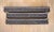 A set of three antique wood and plaster window valances or cornices, stained dark brown, with swags of draped ribbons with...