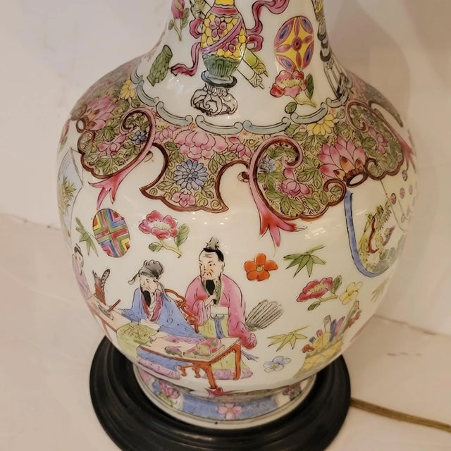 Famille Rose Chinese lamp with new black silk bell shaped shade. Famille rose is an 18th century Chinese porcelain,...