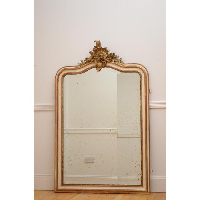 Beautiful French, cream and gold leaf wall mirror, having original bevelled edge glass with some foxing in beaded and...
