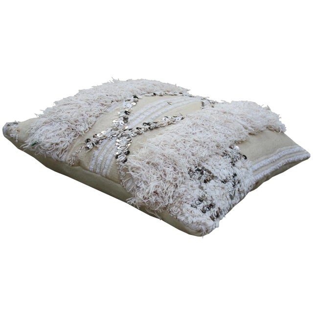 Handwoven Berber wedding pillow from the High Atlas mountains. Features alternating bands of wool fringe and sequins....