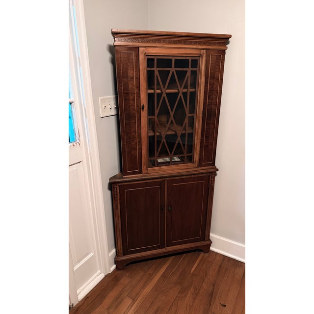 This is an antique English Georgian corner curio cabinet display case, designed to hold and showcase curios and decorative...