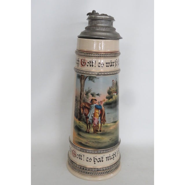 This wonderful Extra Tall Beer Stein is made of ceramic with a pewter lid opened with a winged cherub. The graphic on the...