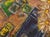 Whimsical abstracted textural still life with three daises and other objects floating through an ambiguous orange space by...
