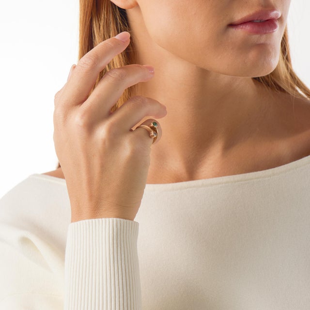 This vintage Toi et Moi ring presents a romantic pairing of an old European cut diamond and a round cut emerald,...