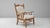 This 20th-century French Provincial oak armchair features a sculpted silhouette that blends rustic craftsmanship with soft...