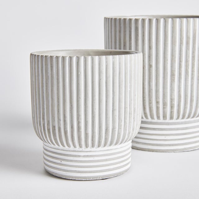 A mixed pattern of horizontal and vertical lines make this set of pots very mod indeed. A translucent white wash artfully...