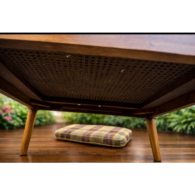 This elegant Regency-style bergère armchair features beautifully preserved hand-woven cane panels on the sides, back, and...