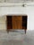 This storage piece features a clean rectilinear form and smooth sliding doors revealing interior shelves. Its minimalist...