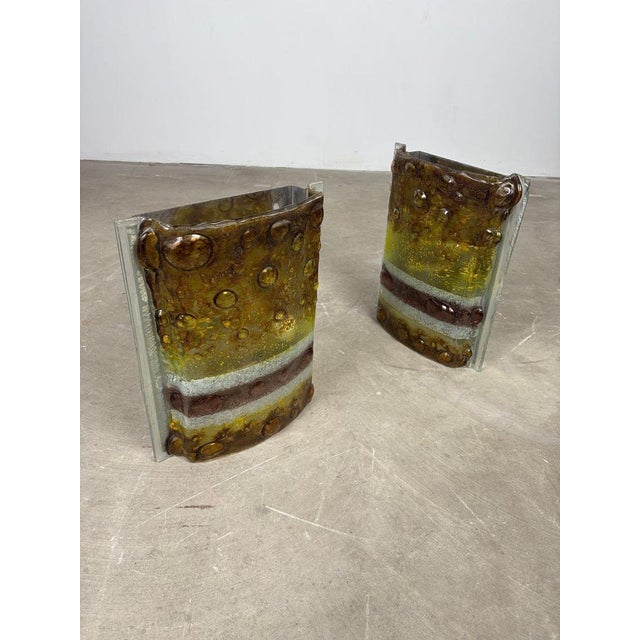 Pair of 1970s Decorative Wall Sconces Elegant pair of original 1970s wall sconces, characterized by a highly decorative...