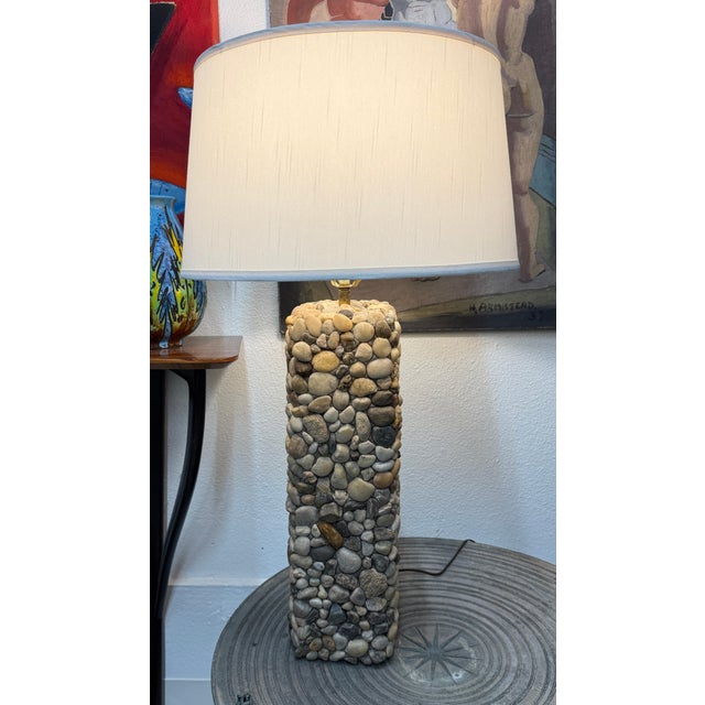 A pretty hand crafted river stone lamp with brass fittings. This lamp is quite beautiful and is uniquely crafted of...