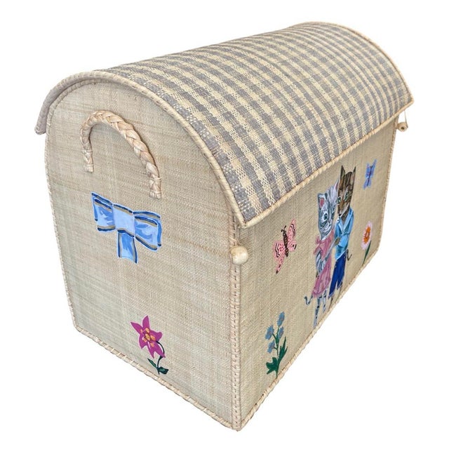 This charming, artisan-crafted toy chest or storage trunk is woven from natural raffia, featuring a distinctively...
