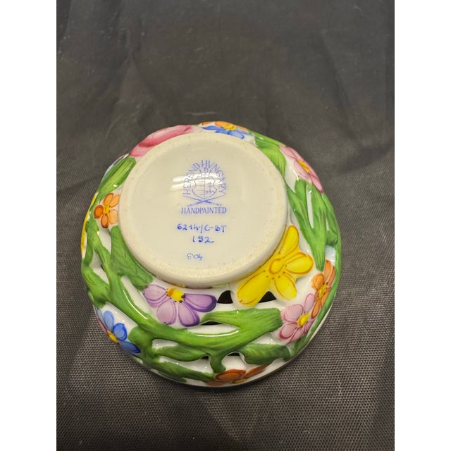 This vintage Herend Hungary porcelain box features a round shape with a strawberry finial, standing at 3.75 inches tall...