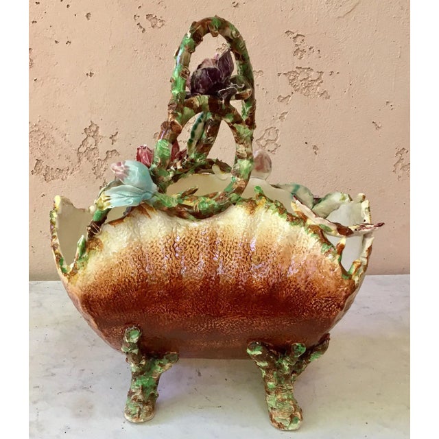 Antique French majolica basket with flowers and butterfly, bug, and insect accents, circa 1880. No maker's mark. Some chips.