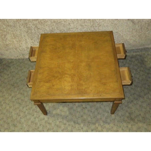 This Coffee Table has a Mid Century Style. Made By Baker Furniture. The Table has a Burl Top w/Four Drawers. All Wood. The...