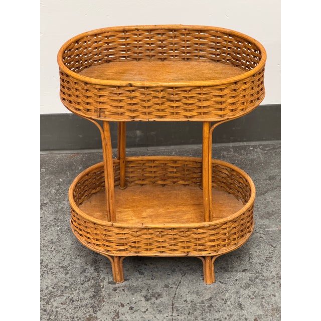 Design Plus Gallery presents a Mid 20th Century Vintage Accent Table from Rattan. Handwoven rattan wraps the upper and...