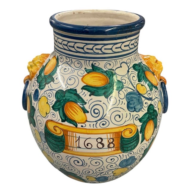 Bring the sun-drenched romance of the Mediterranean indoors with this striking vintage Italian Majolica-style ceramic urn....