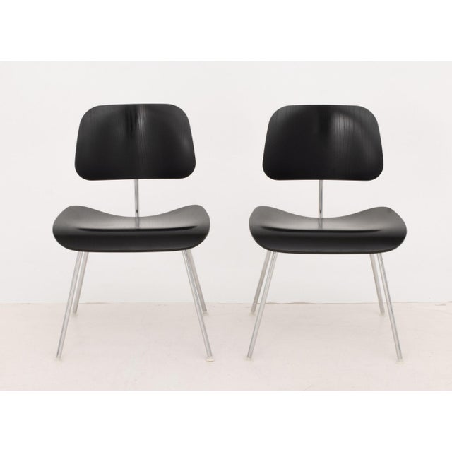 Pair of Charles and Ray Eames for Herman Miller DCM Ebonized Molded Plywood Chairs, with chrome-plated metal bases and...