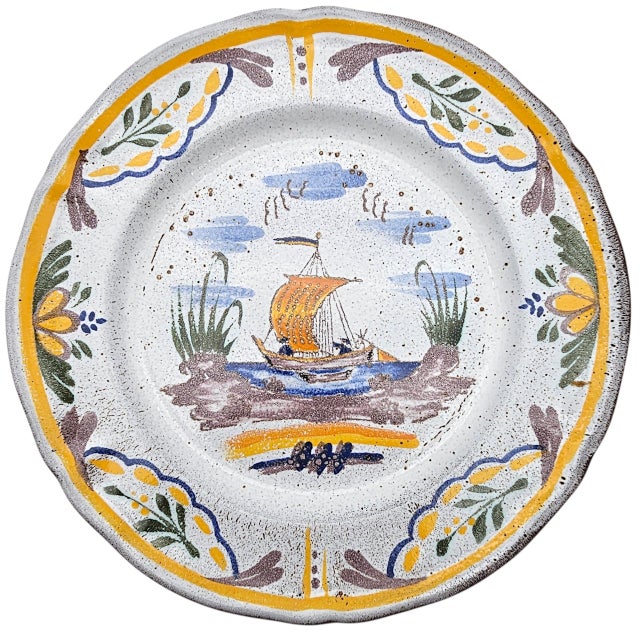 This hand-painted faience plate was produced in France as part of mid-twentieth-century studio pottery traditions. Marked...