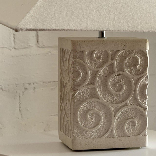 A one-of-a-kind hand carved stone table lamp with swirl motif. Extremely heavy. Paired here with one of studio & store’s...
