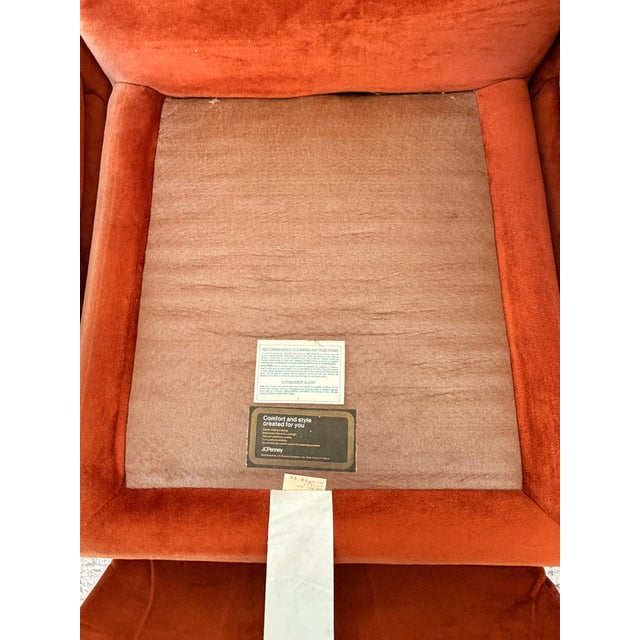 A striking vintage modular sectional sofa in a rich burnt orange velvet, embodying the bold comfort and sculptural design...