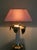 This lamp is a vintage design piece from the 1970s. It features a tropical, glamorous, and luxurious style, typical of the...